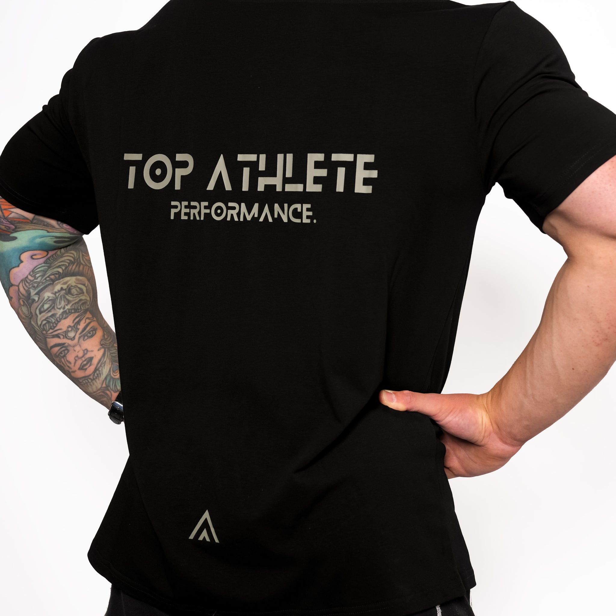 Back view of man wearing black colour Top Athlete unisex activewear t-shirt.