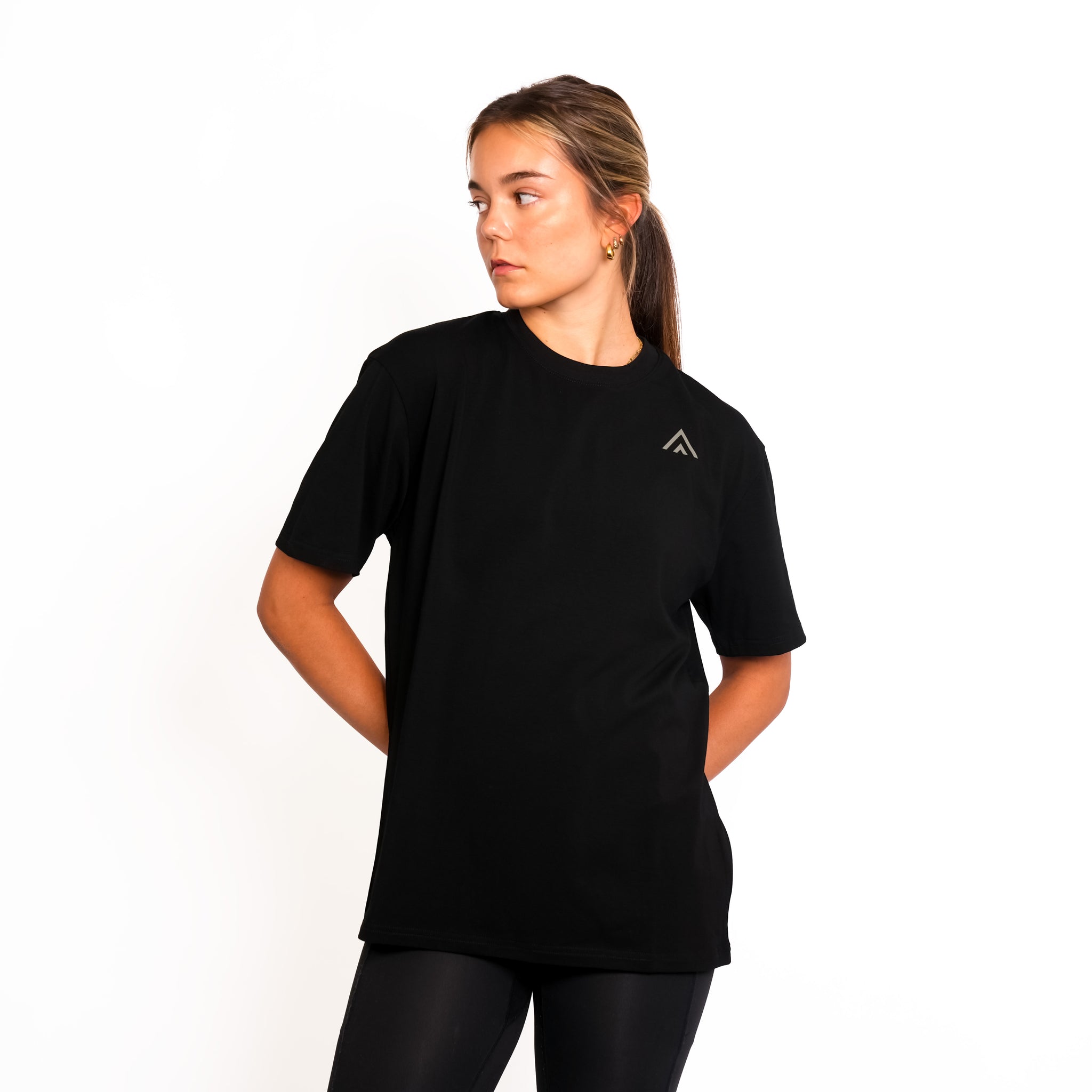 Front view of woman wearing black colour Top Athlete unisex oversized activewear t-shirt.