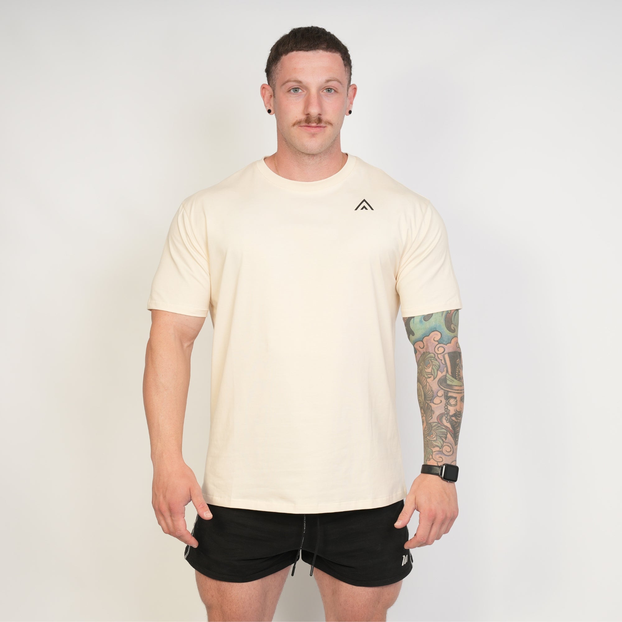 Man wearing a beige top athlete performance tee