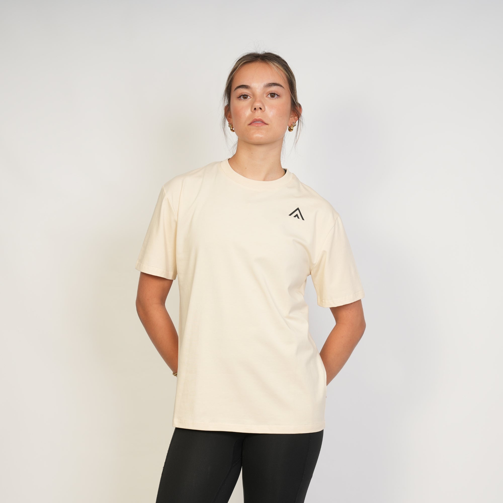 Woman wearing a beige top athlete performance tee