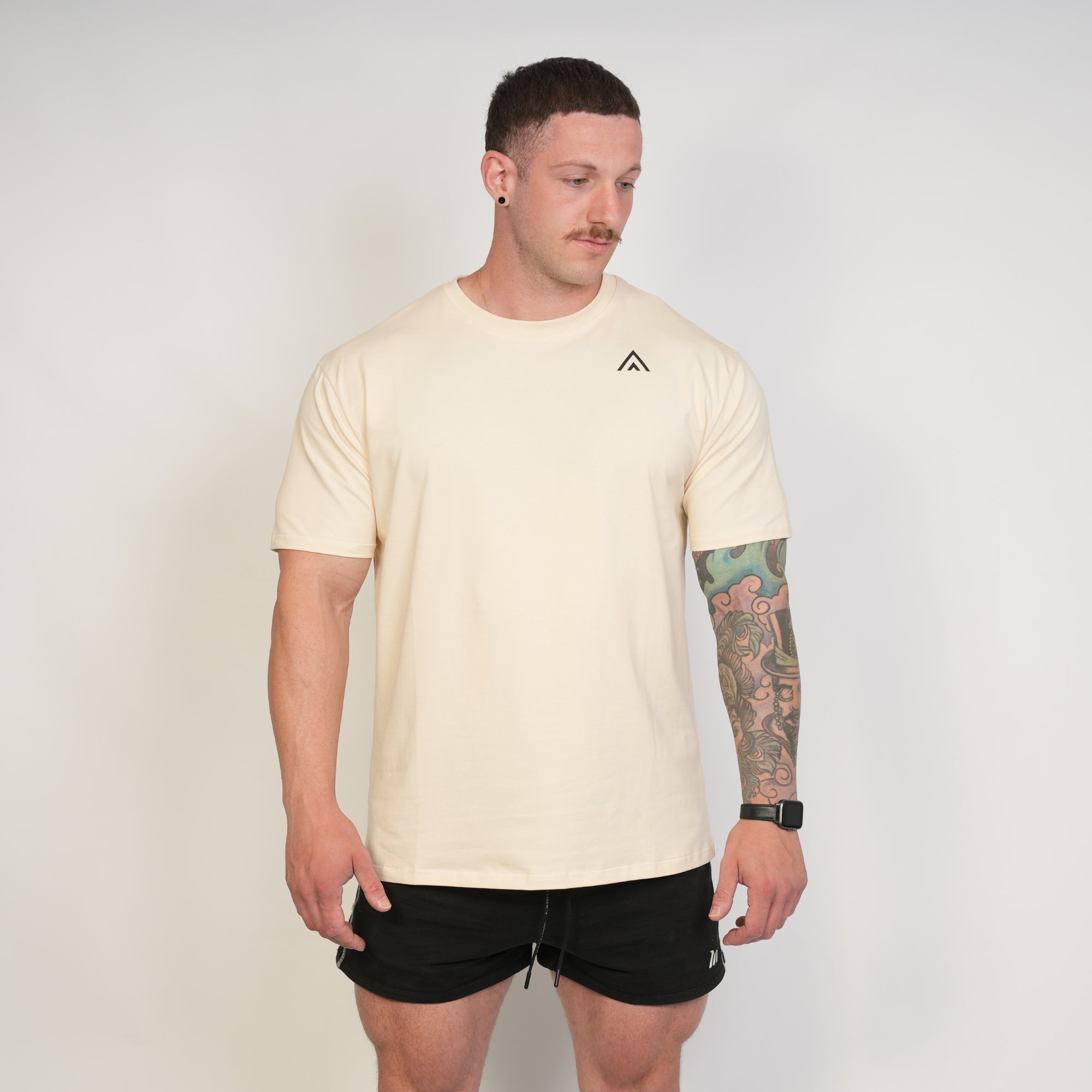 Man wearing a beige top athlete performance tee