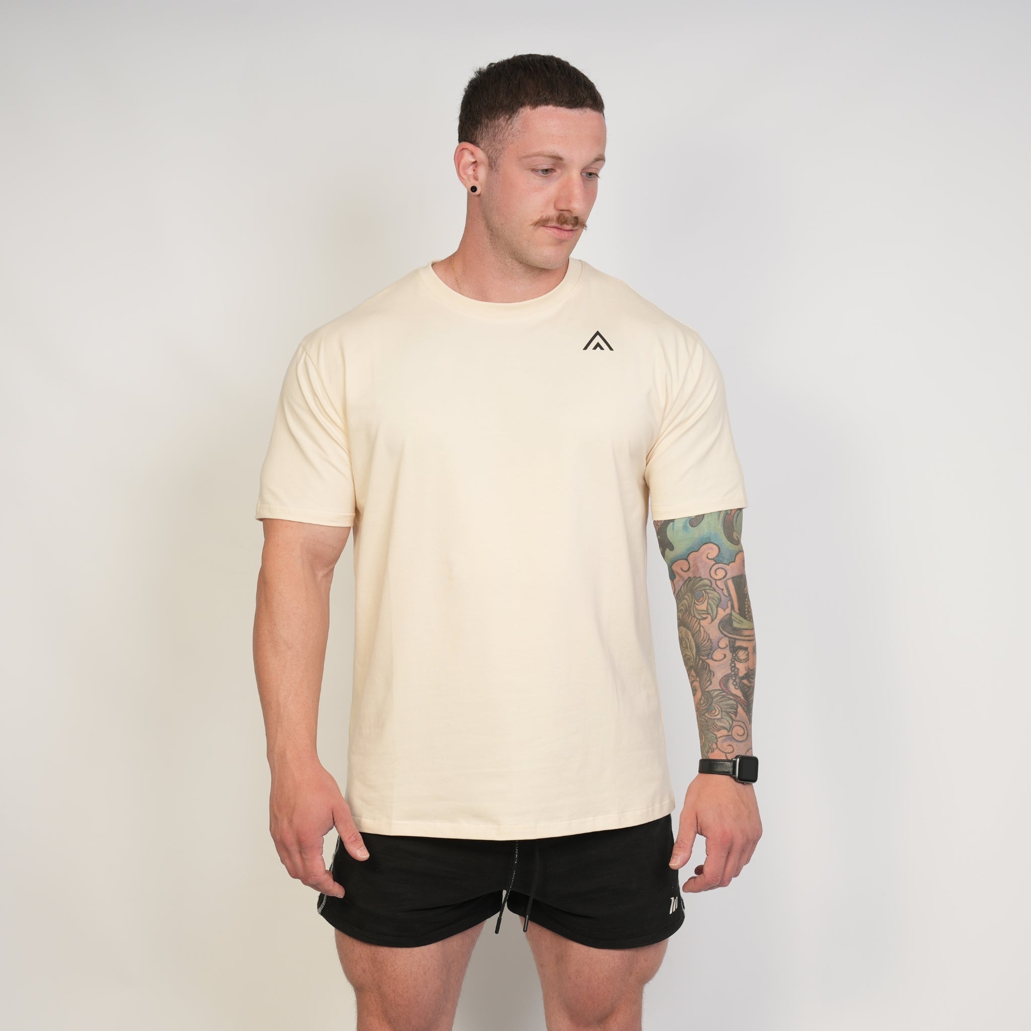 Man wearing a beige top athlete performance tee