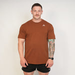 Man wearing a Top athlete brown/bronze performance tee