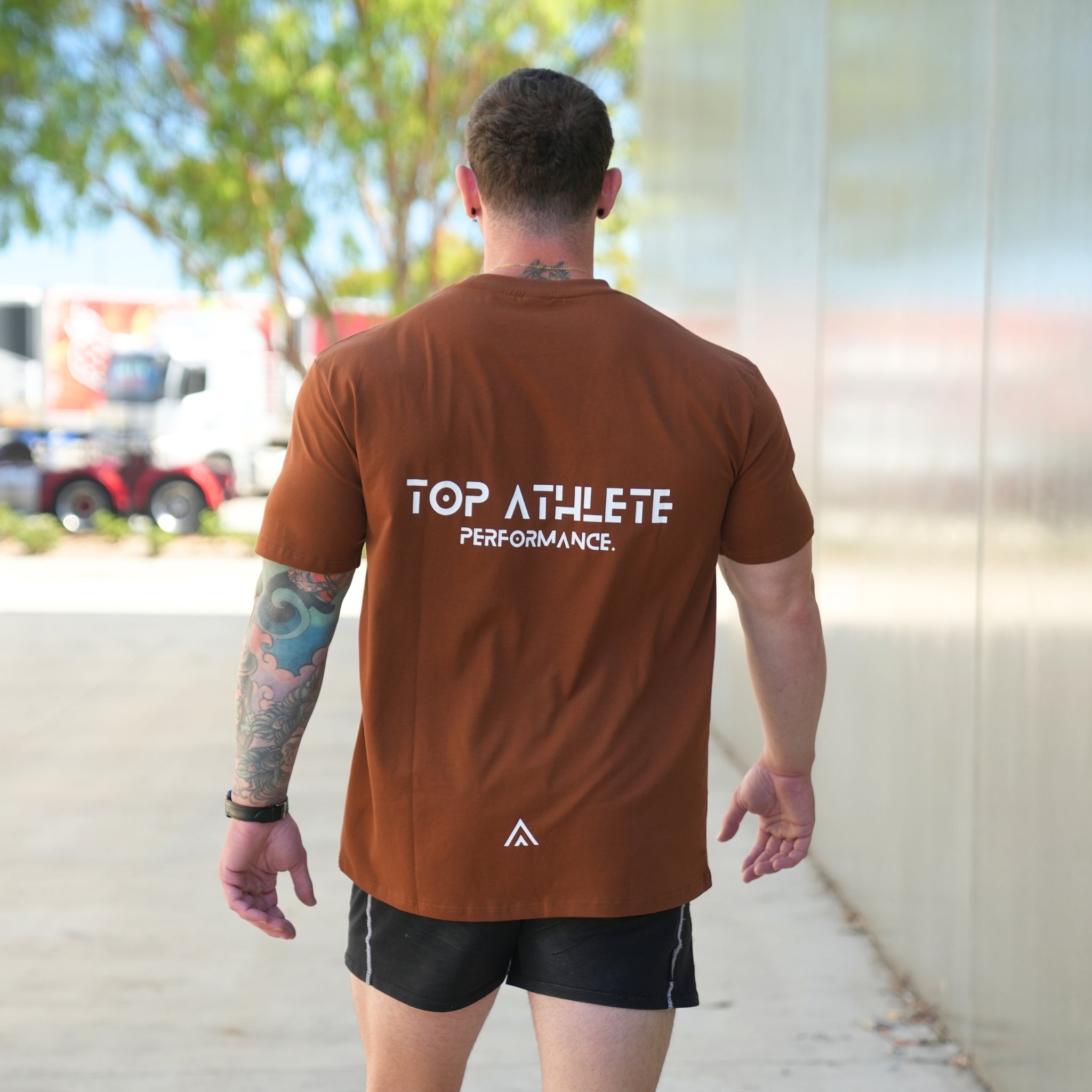 Man wearing a Top athlete brown/bronze performance tee