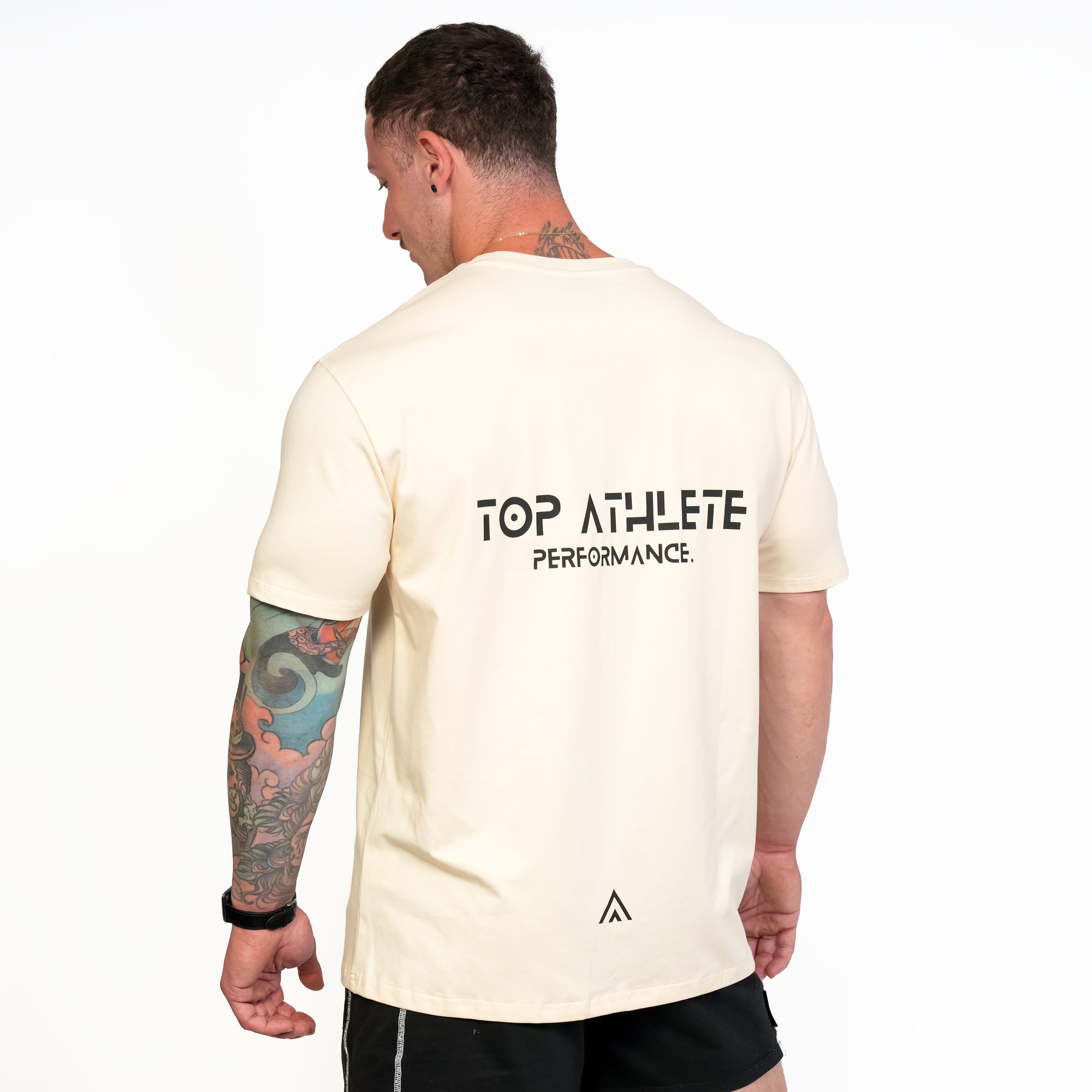 Back view of man wearing beige colour Top Athlete unisex activewear t-shirt.