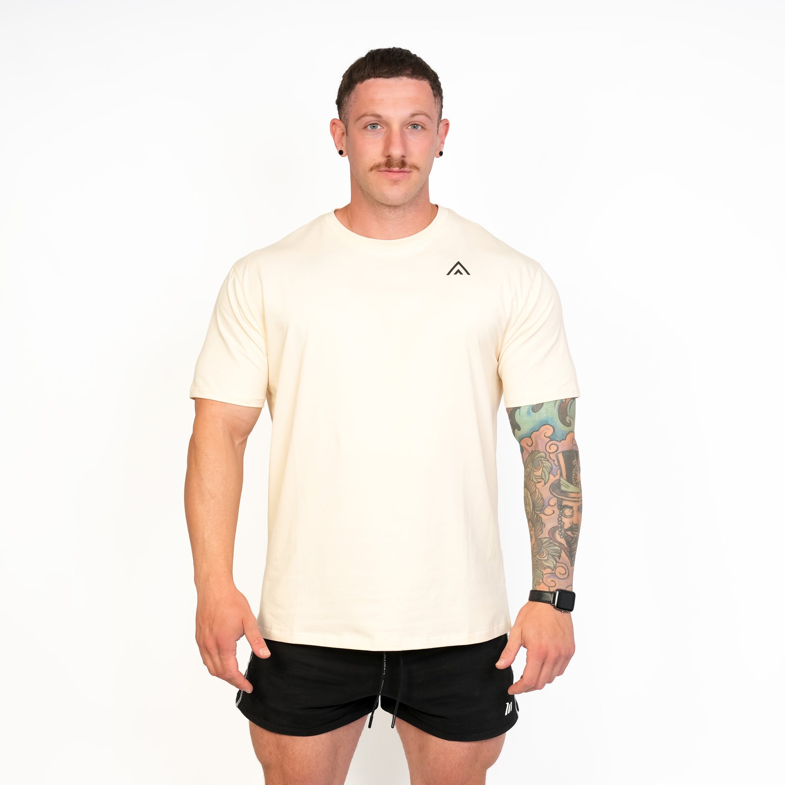 Front view of man wearing beige colour Top Athlete unisex activewear t-shirt.