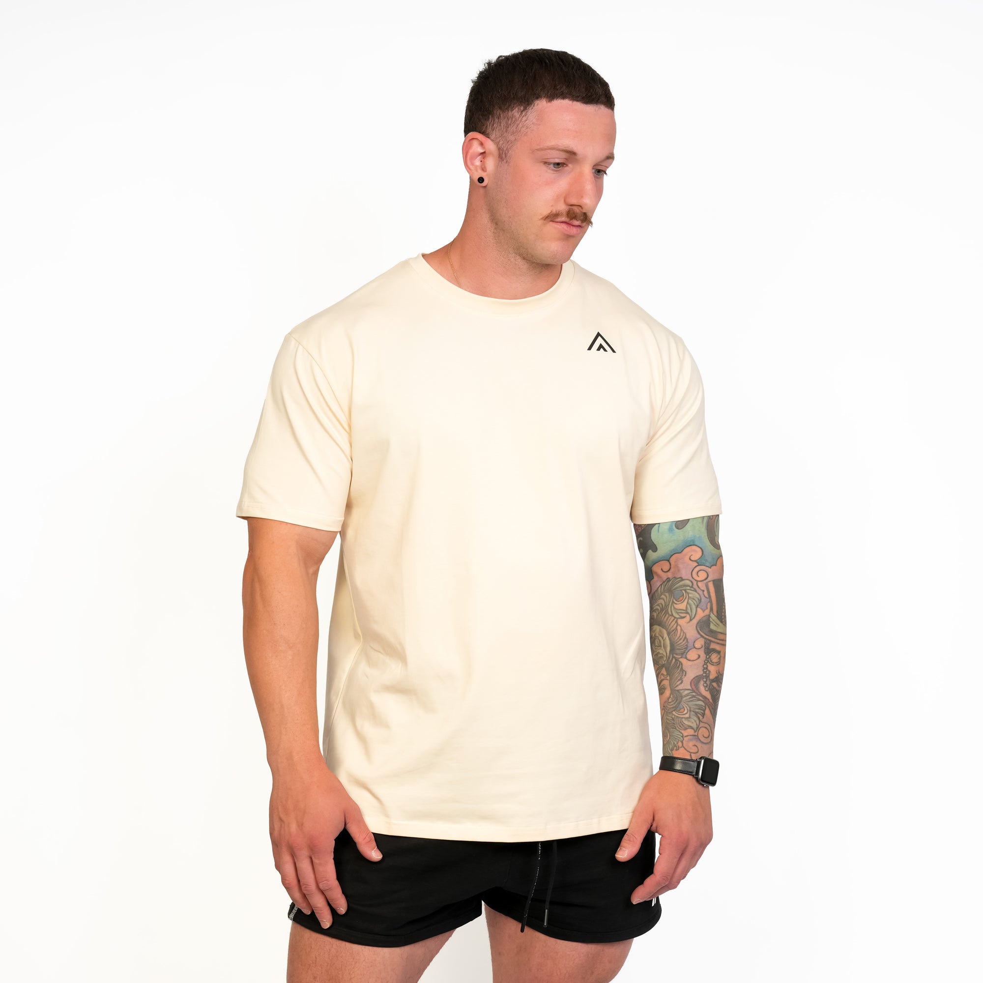 Front view of man wearing beige colour Top Athlete unisex activewear t-shirt.