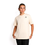 Front view of woman wearing beige colour Top Athlete unisex oversized activewear t-shirt.