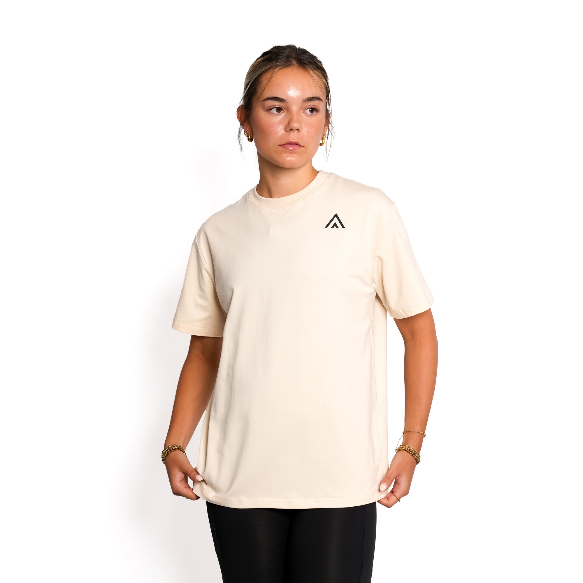 Front view of woman wearing beige colour Top Athlete unisex oversized activewear t-shirt.