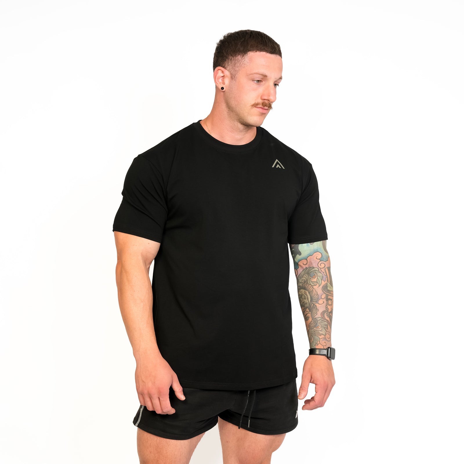 Front view of man wearing black colour Top Athlete unisex activewear t-shirt.