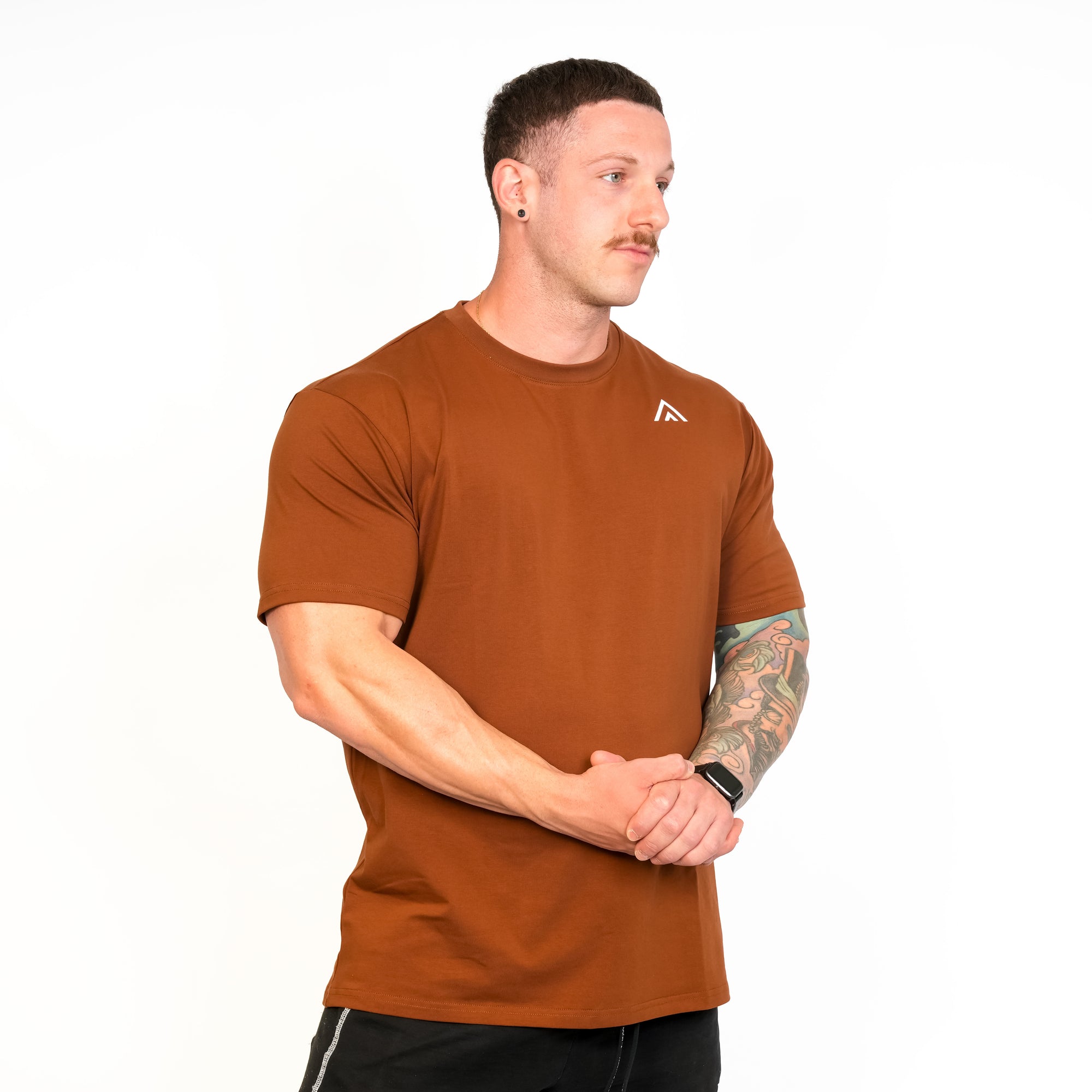 Front view of man wearing bronze colour Top Athlete unisex activewear t-shirt.