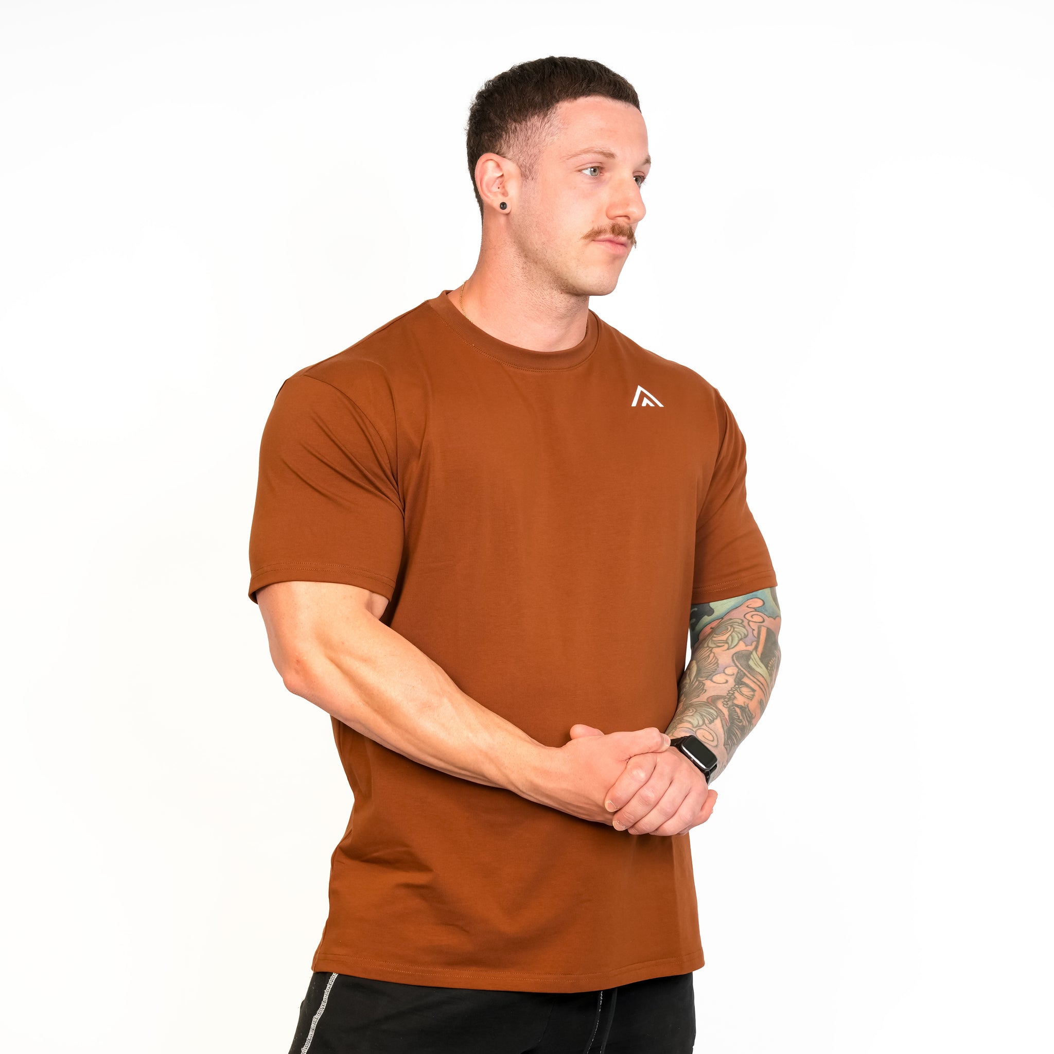 Front view of man wearing bronze colour Top Athlete unisex activewear t-shirt.