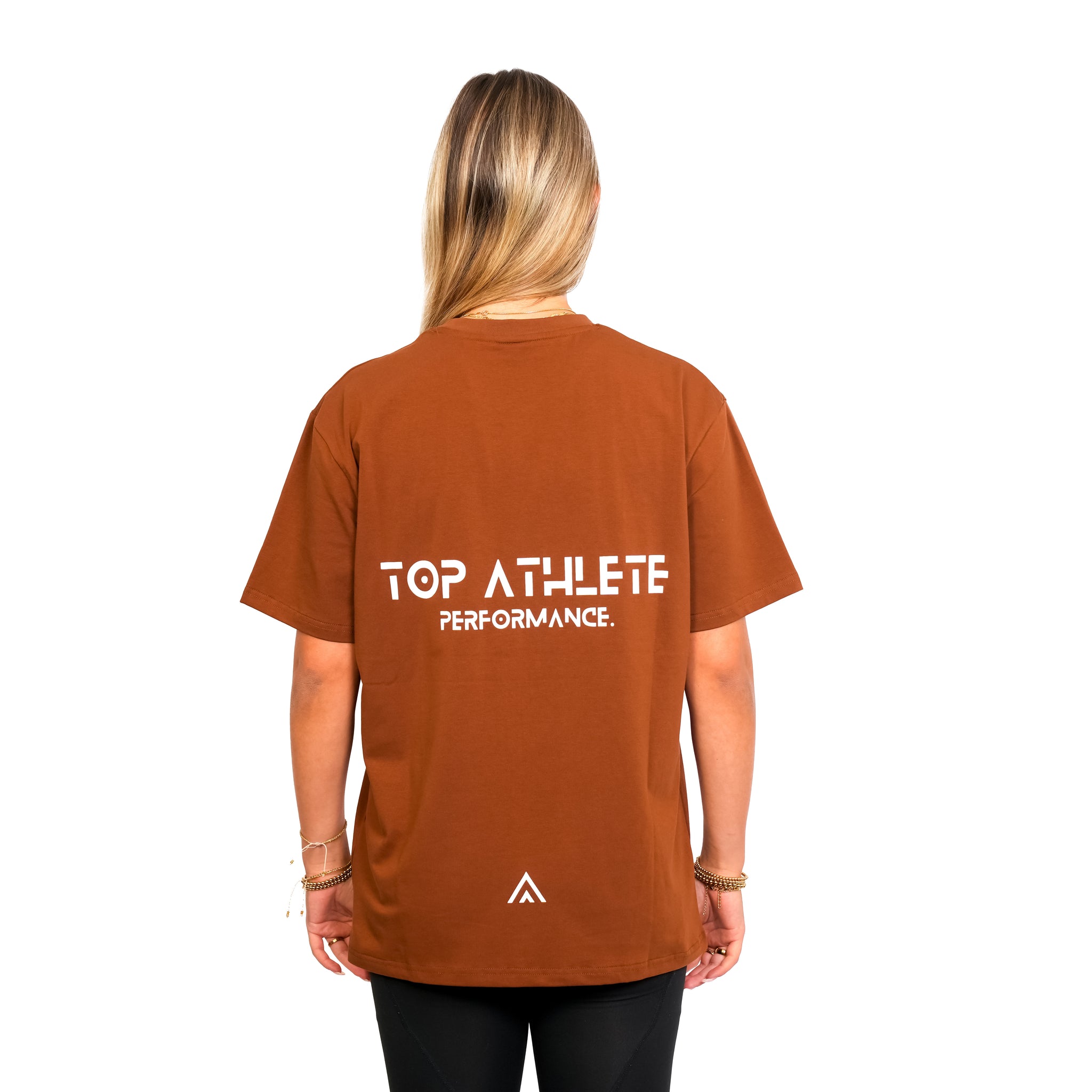 Back view of woman wearing bronze colour Top Athlete unisex oversized activewear t-shirt.