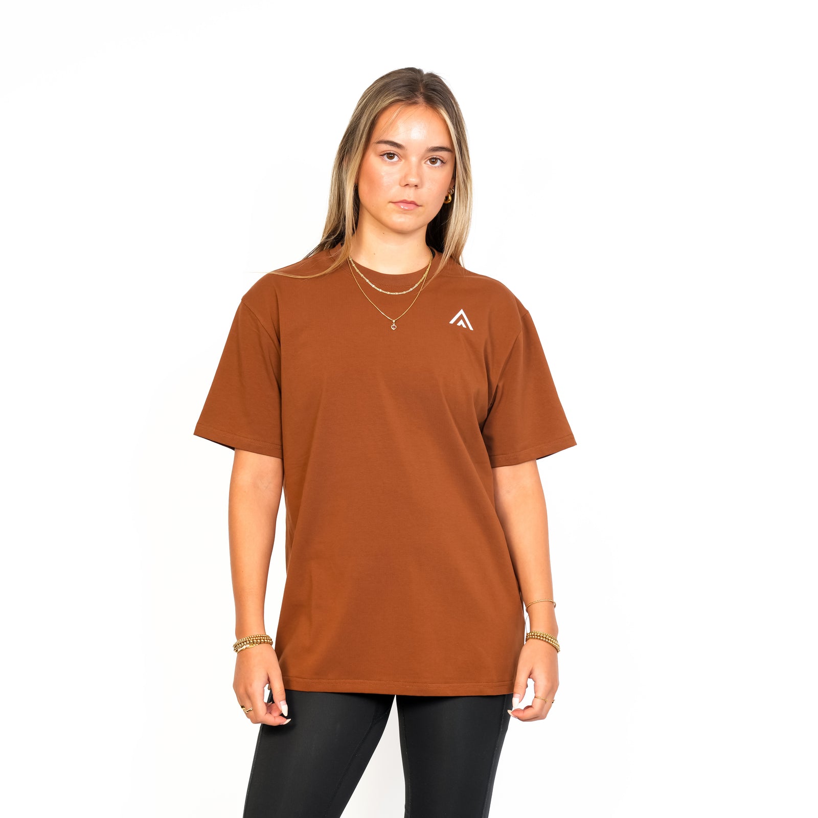 Front view of woman wearing bronze colour Top Athlete unisex oversized activewear t-shirt. 